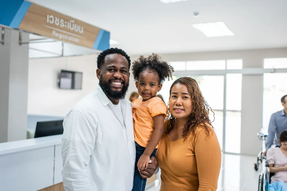 A family standing together in a hospital registration area